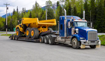 Heavy-duty dump truck on flatbed trailer