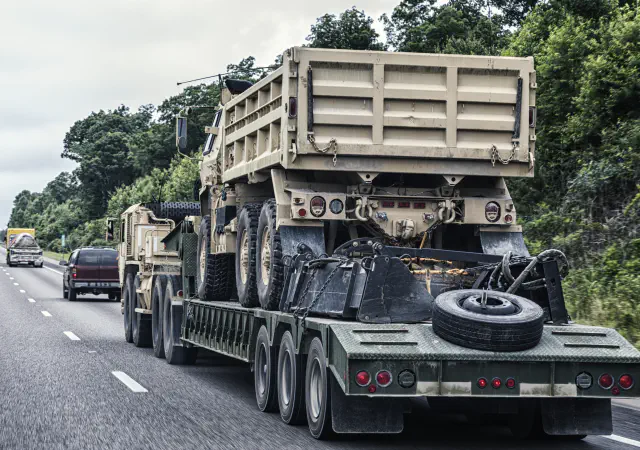 Military vehicles on a hauler